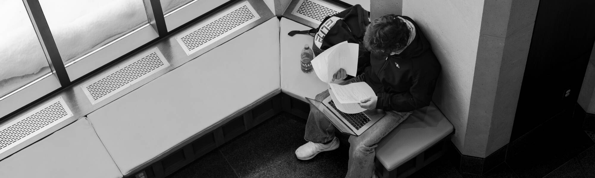 Top view of a student studying in black and white